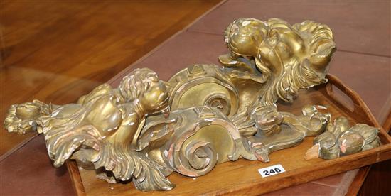 A pair of Victorian carved giltwood appliqués, modelled with lions head and fruiting drops, 47cm